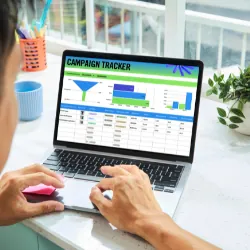 Man on laptop looking at campaign maangement site.