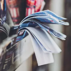 Flyers hanging out of purse pocket or box on door